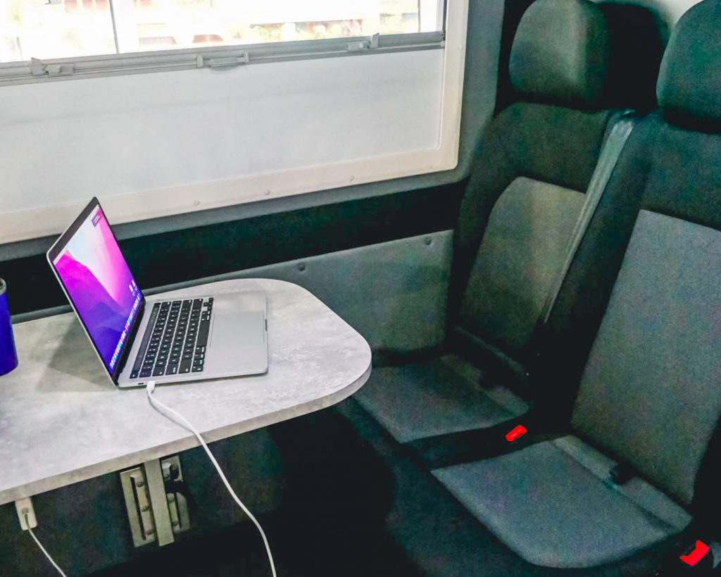 Desk with laptop charging in a motorhome